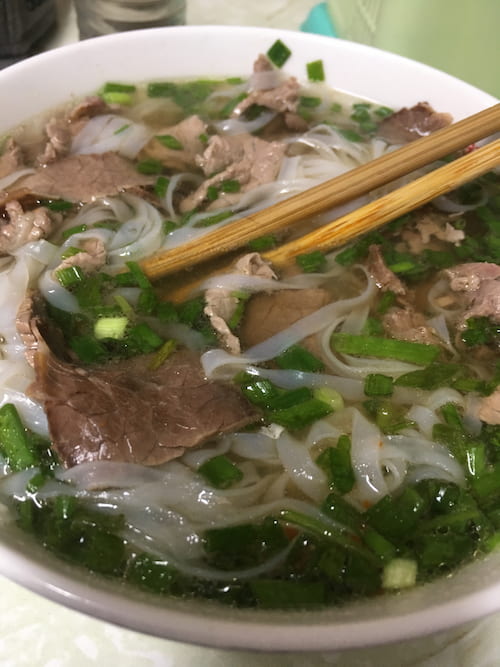 A bowl of phở bò tái -- rare beef phở -- photographed in Hanoi, Vietnam